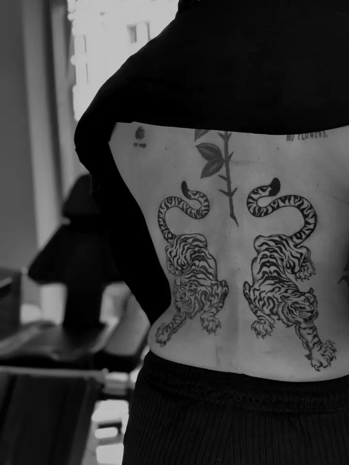 To tigre og en rosestilk på ryggen, blackwork av Camilla